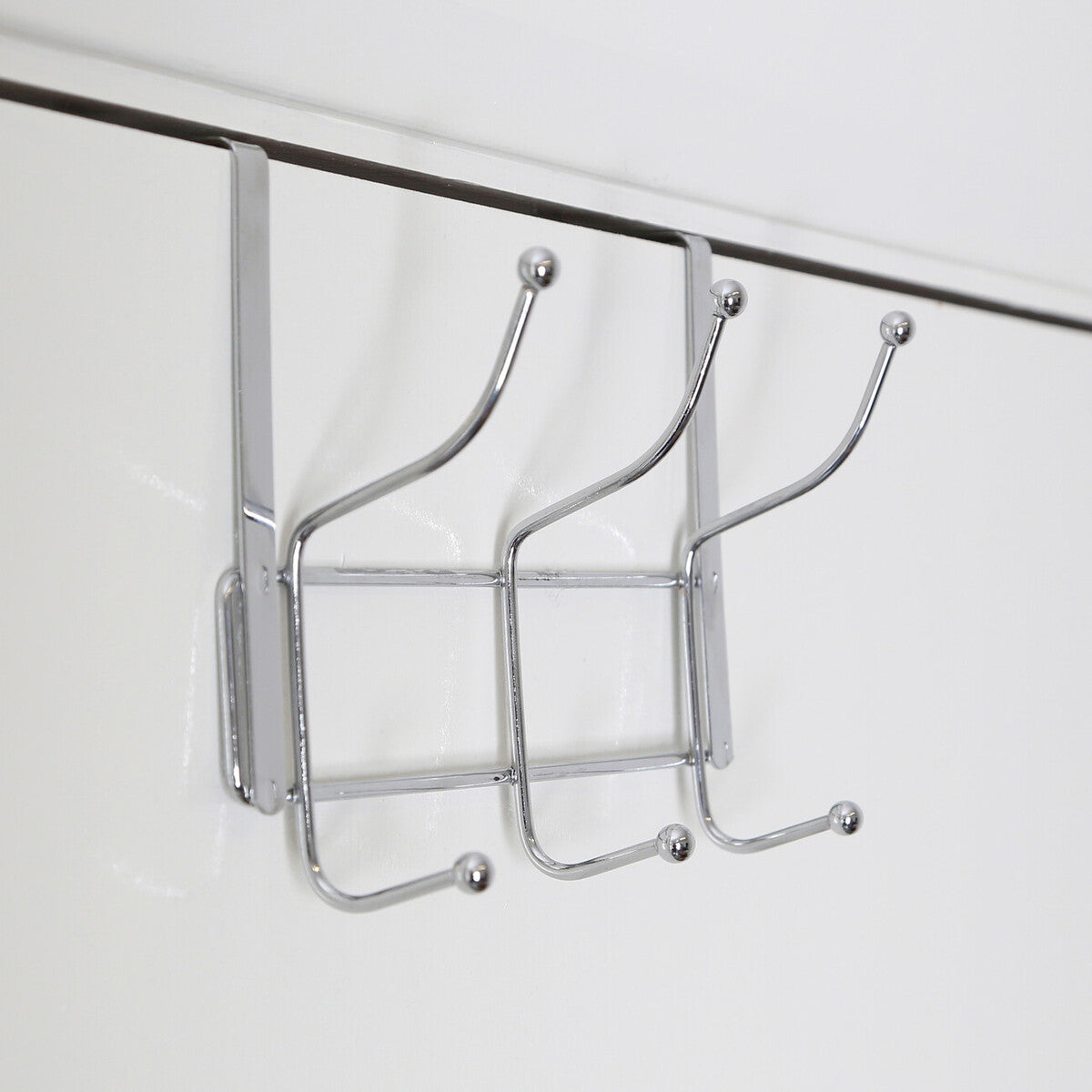 Chrome finished metal over door six hook hanger with three curved hooks and grid design for hanging items
