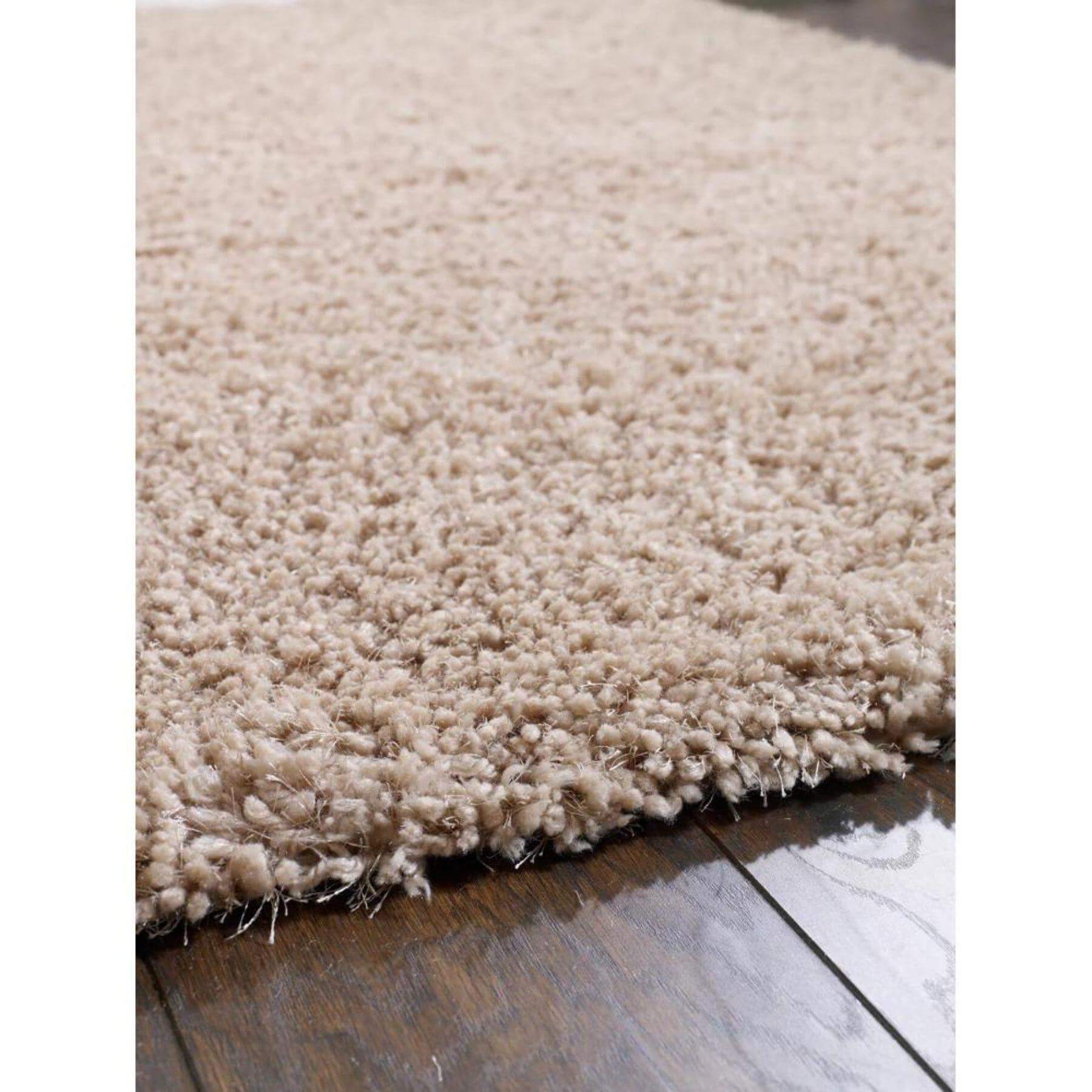 Beige chicago latte shaggy rug with plush textured surface and slightly frayed edges perfect for cozy spaces