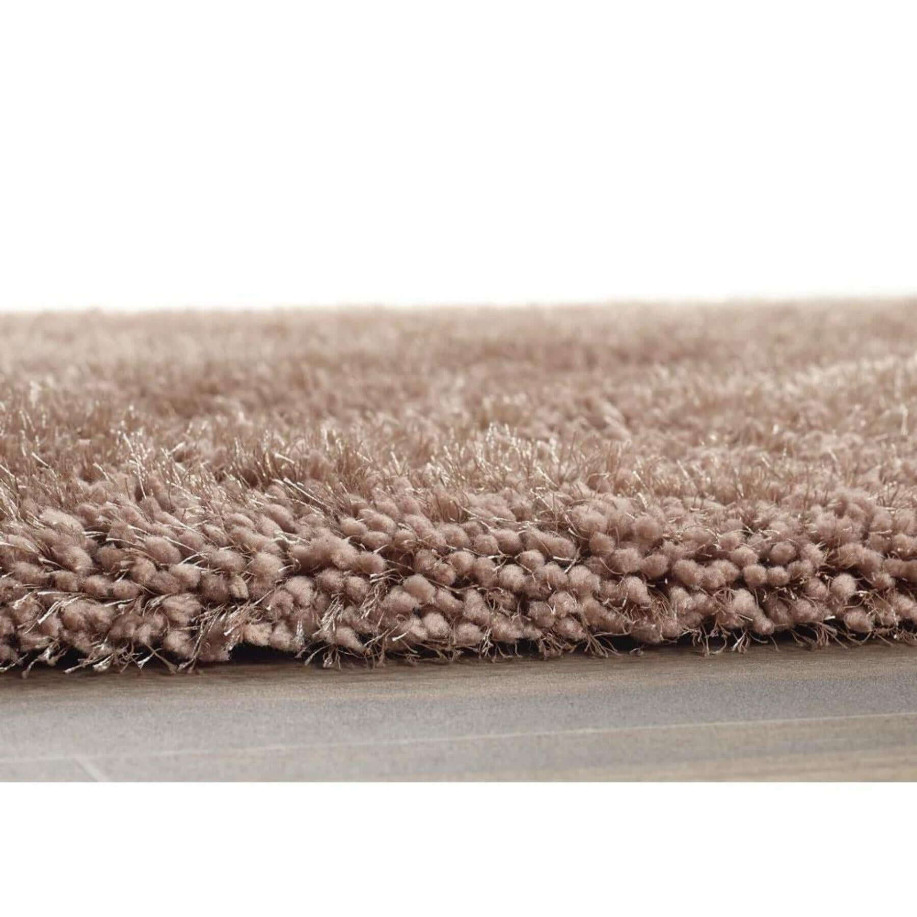 A plush beige chicago latte shaggy rug with dense textured pile and slightly frayed edges for cozy decor
