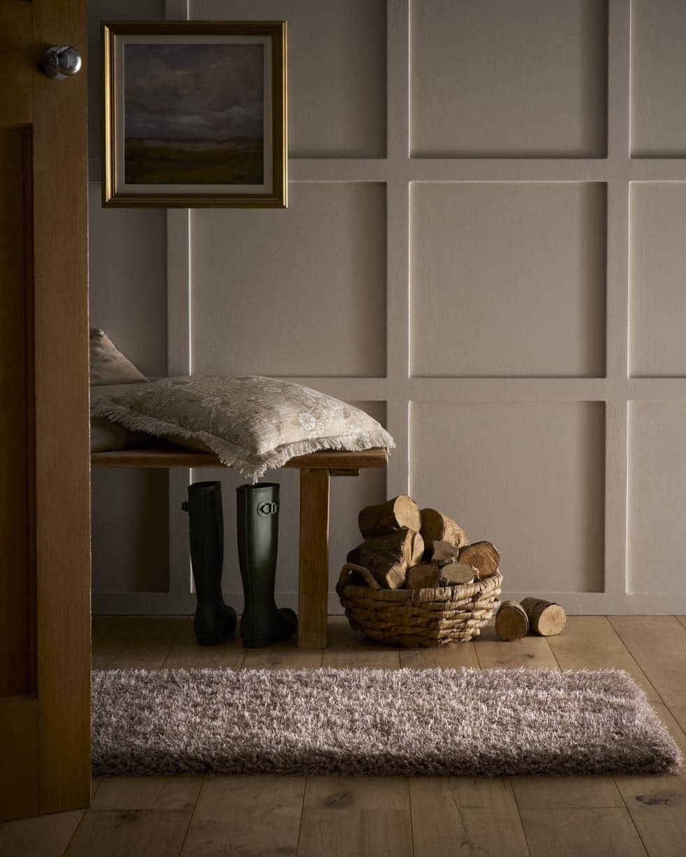 A plush textured gray chicago latte shaggy rug with a soft shaggy surface on a wooden floor