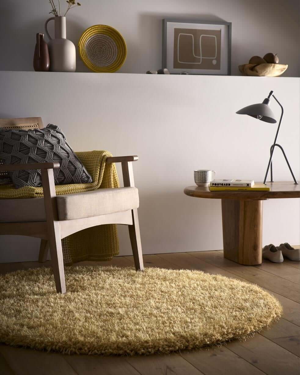 A round plush yellow chicago ochre shaggy rug with a soft textured surface perfect for cozy spaces