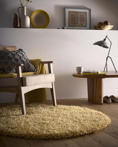 A round plush yellow chicago ochre shaggy rug with a soft textured surface perfect for cozy spaces