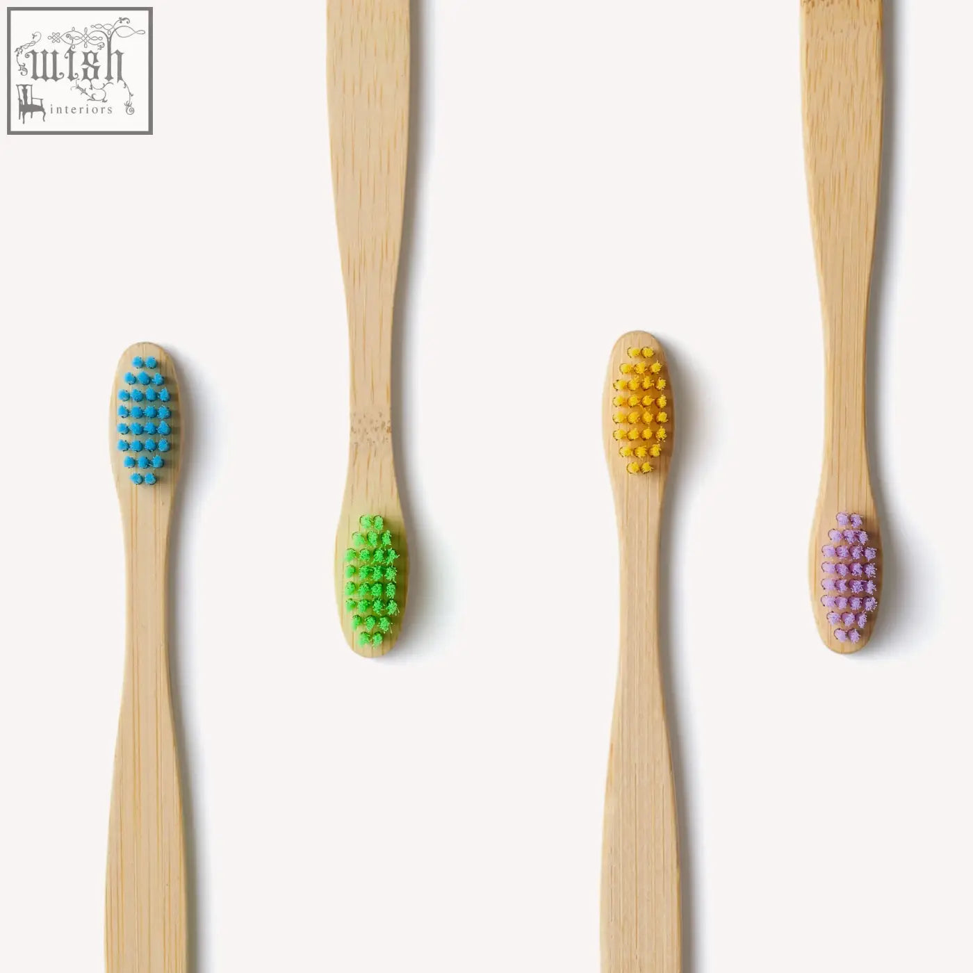 Four certified bamboo toothbrushes for children with colorful blue green yellow and purple bristles in a 4 pack