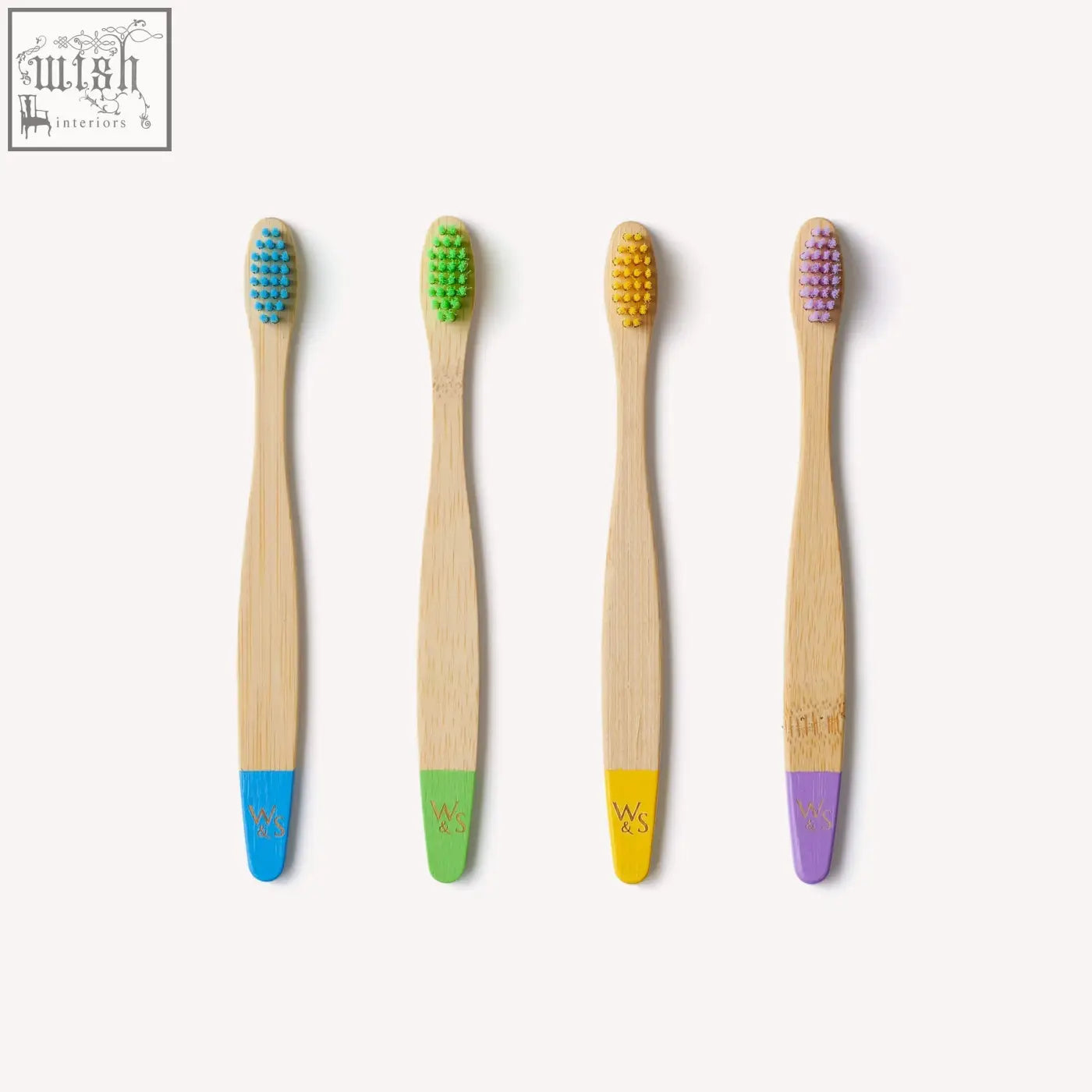 Set of four certified bamboo toothbrushes for children with colorful bristles and matching handle accents