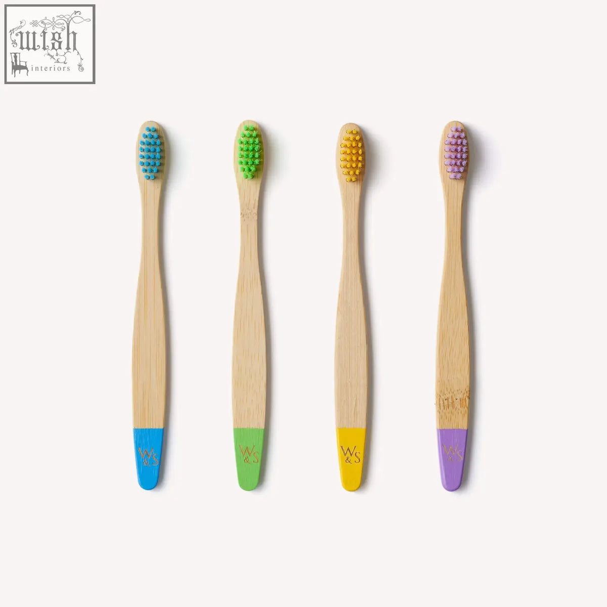Set of four certified bamboo toothbrushes for children with colorful bristles and matching handle accents