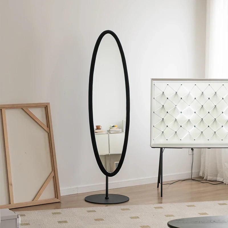 Black oval floor mirror with sleek minimalist frame and circular base perfect for modern spaces chinatsu mirror