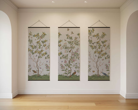 Three elegant chinoiserie tree tapestries with green and pink floral patterns and birds on beige fabric hanging vertically