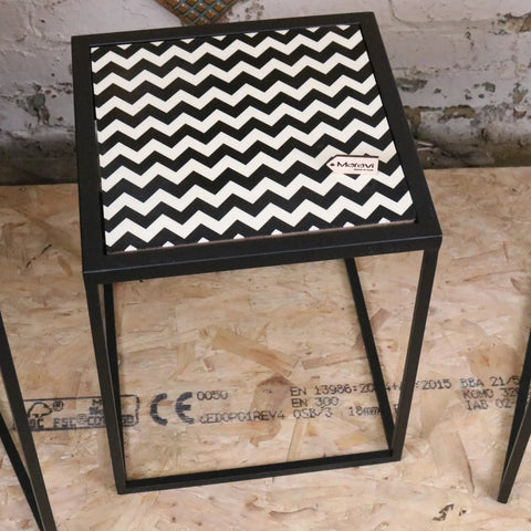 Chinta modern black square nesting side tables with black metal frame and bold black and white resin tabletops