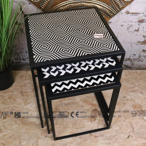 Chinta modern black square nesting side tables with black metal frames and resin tabletops featuring bold white hexagonal patterns