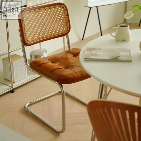 Brown leather tufted chloe rattan dining chair with woven cane back and chrome metal frame perfect for dining
