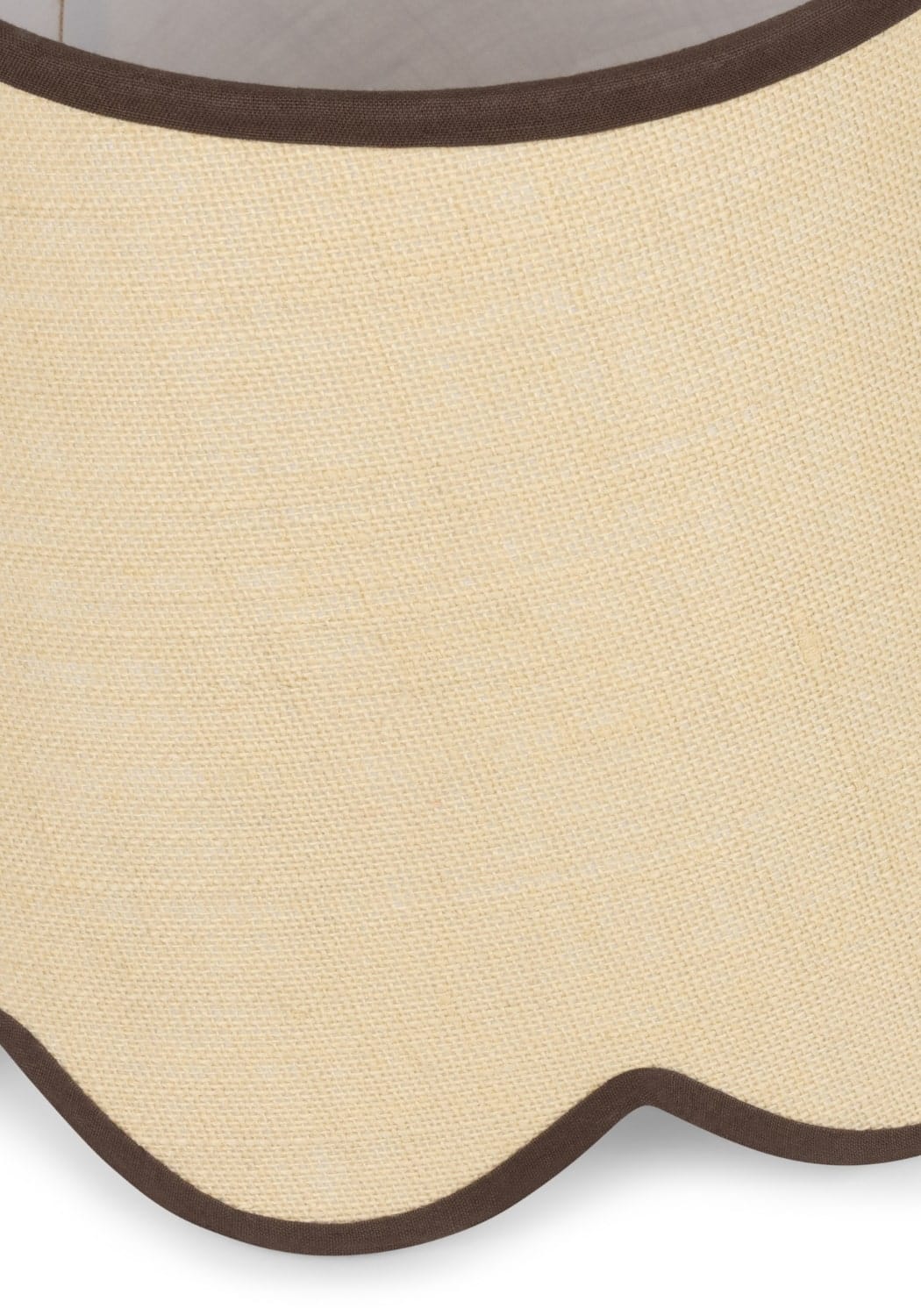Beige linen placemat with scalloped edge and dark brown trim paired with chocolate brown jute scallop lampshade