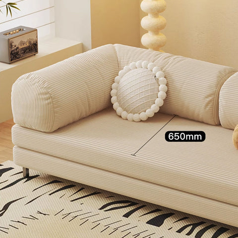 Beige corduroy choudhury two seater sofa bed with a round white pom-pom cushion and washable backrest