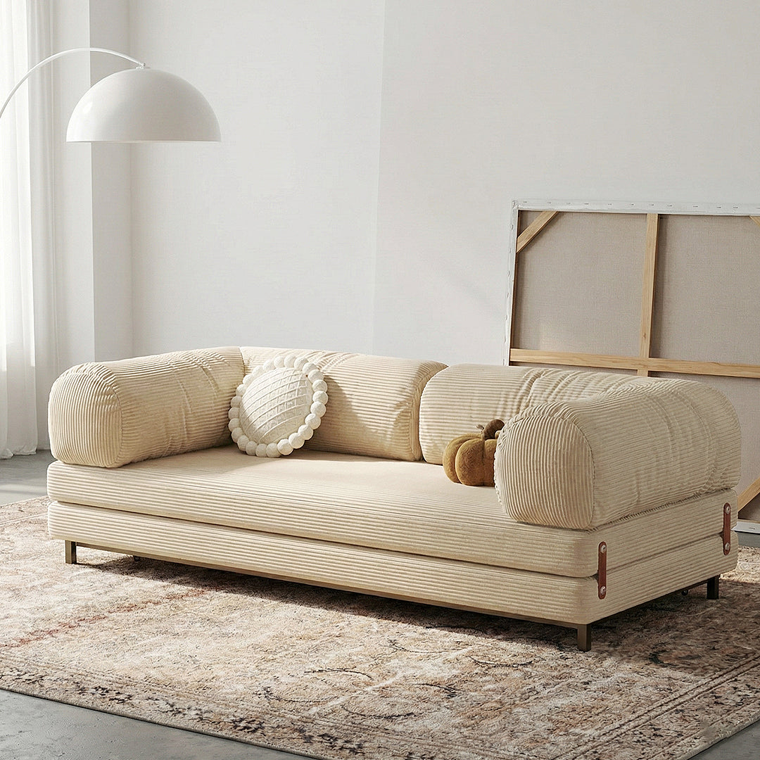 Cream-colored corduroy sofa bed with rounded armrests and ribbed fabric finish choudhury two seater sofa bed