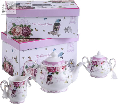 A delicate porcelain teapot with birds and roses pink floral tea set includes milk jug tier cake stand and cups