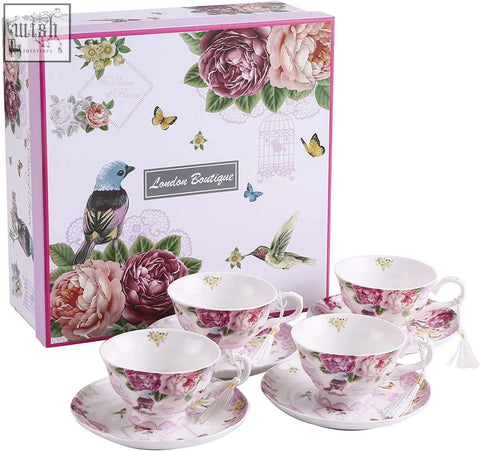 Set of four delicate porcelain teacups and saucers with floral pattern in soft pink mauve for tier cake stand use