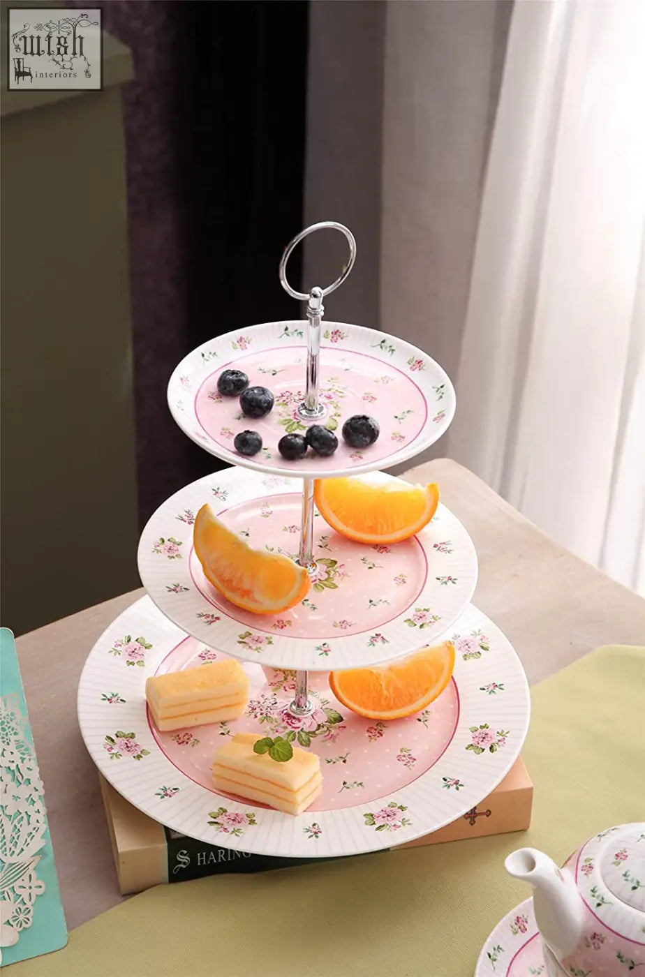 Pink floral-patterned ceramic tier cake stand with silver support perfect for milk jug and festive family parties