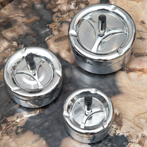 Three shiny chrome effect medium spinning ashtrays with black stems and leaf-shaped cutouts for easy use