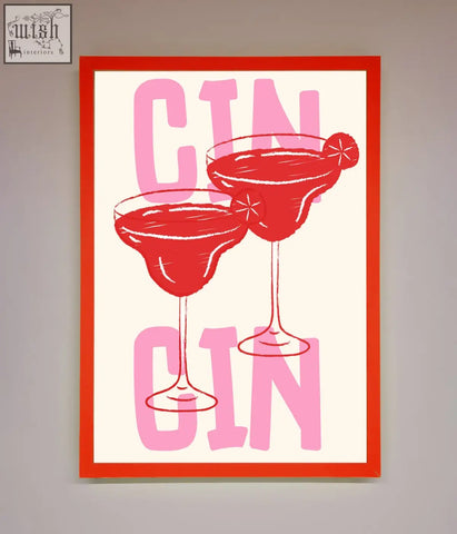 A vibrant red-framed cin cin framed print showing two gin cocktails in martini glasses with pink lettering