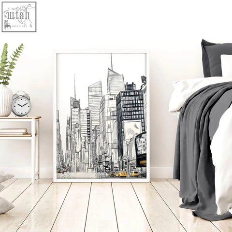 A set of 2 city prints wall art featuring black and white urban skyscrapers with subtle yellow accents in white frames