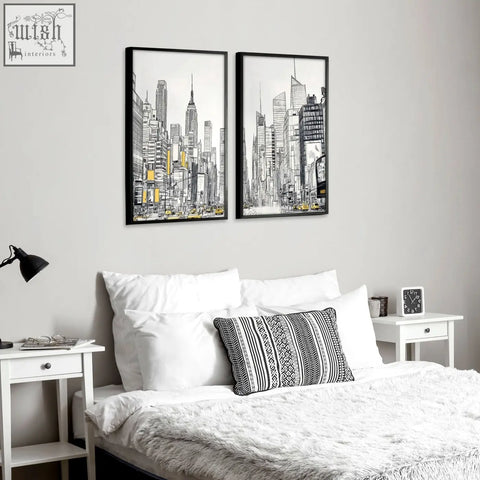 Two black-framed city prints wall art featuring monochrome skyscrapers with yellow accents for urban decor