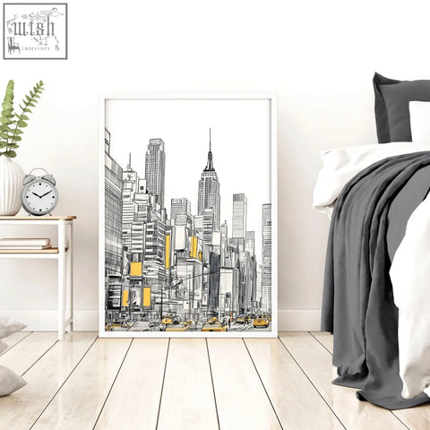 White-framed city prints wall art featuring black and white skyscraper line drawing with yellow accents for urban decor