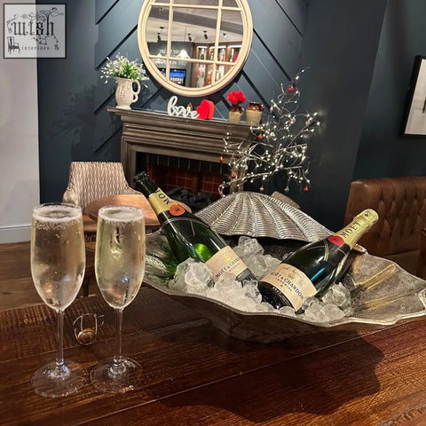 Silver leaf-shaped clamshell solid ice bucket with scalloped edge and textured surface for chilling champagne