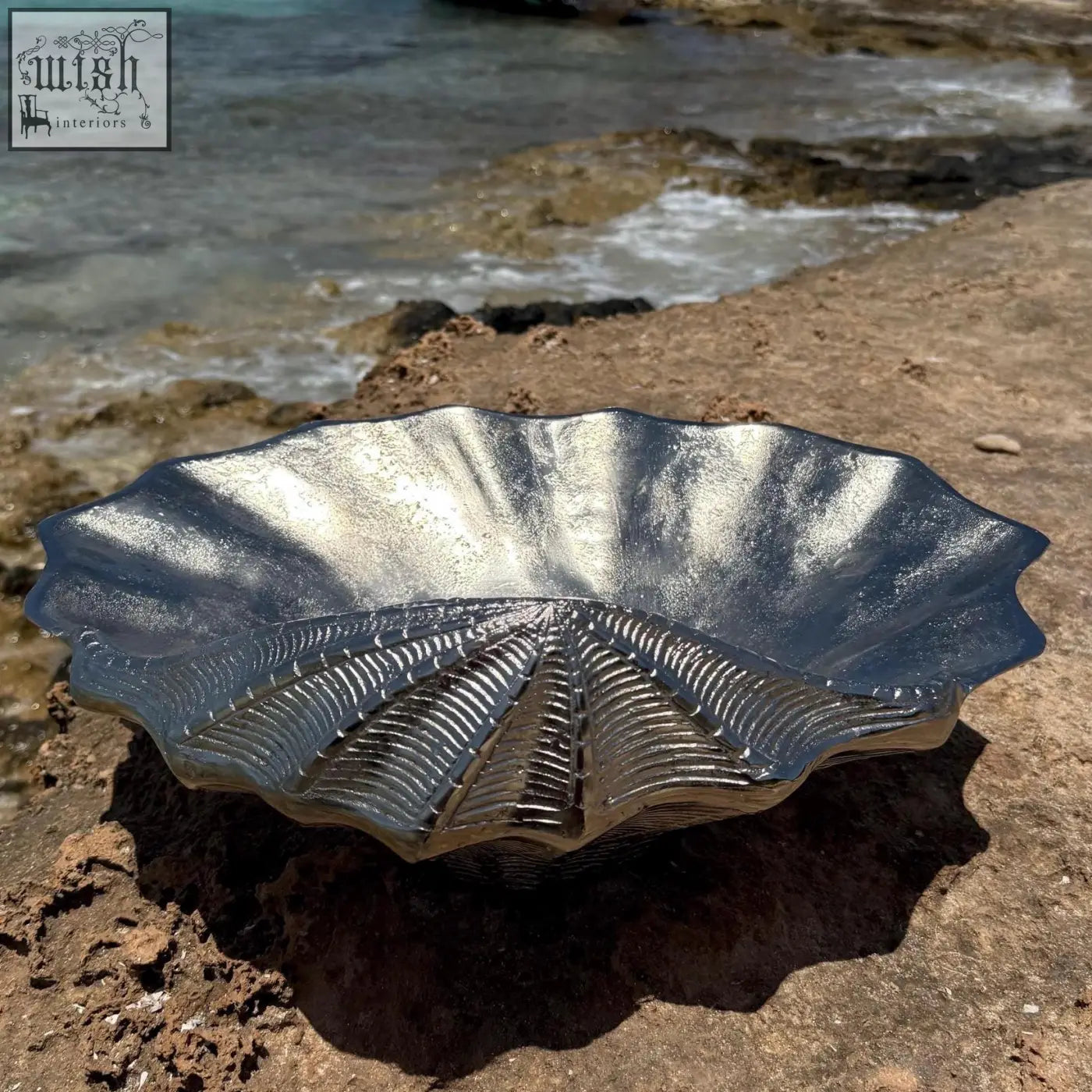Silver leaf-shaped glass ice bucket with textured ribbed interior and scalloped edges for chilling wine or champagne