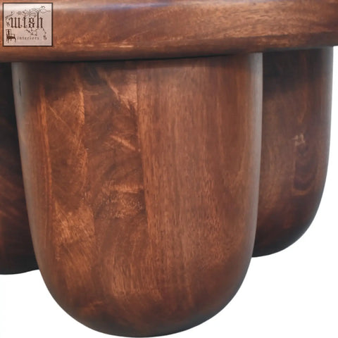 Clara sculpted coffee table with rich warm tones and rounded legs made from solid mango wood oak hand carved