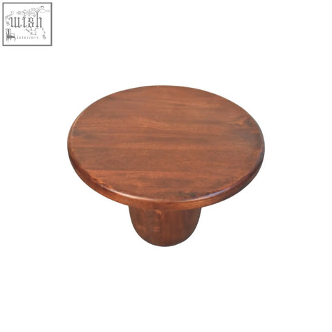 Clara sculpted coffee table with a round solid mango wood top and single pedestal base in rich brown finish