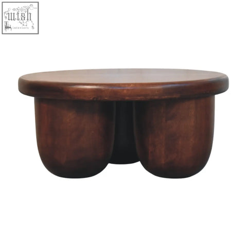 Clara sculpted coffee table in sleek dark brown solid mango wood with smooth rounded top and sturdy curved legs