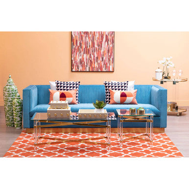 Bright blue upholstered sofa with geometric throw pillows complements the clarence range for rooms feeling open