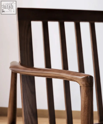 Dark brown wooden classic c02 armchair with slatted back and curved armrest featuring green leather seat