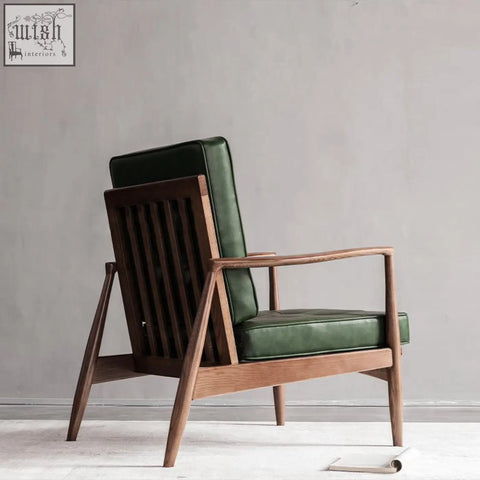 Classic c02 armchair with green leather upholstery and dark wood frame is a stylish leather armchair for any room