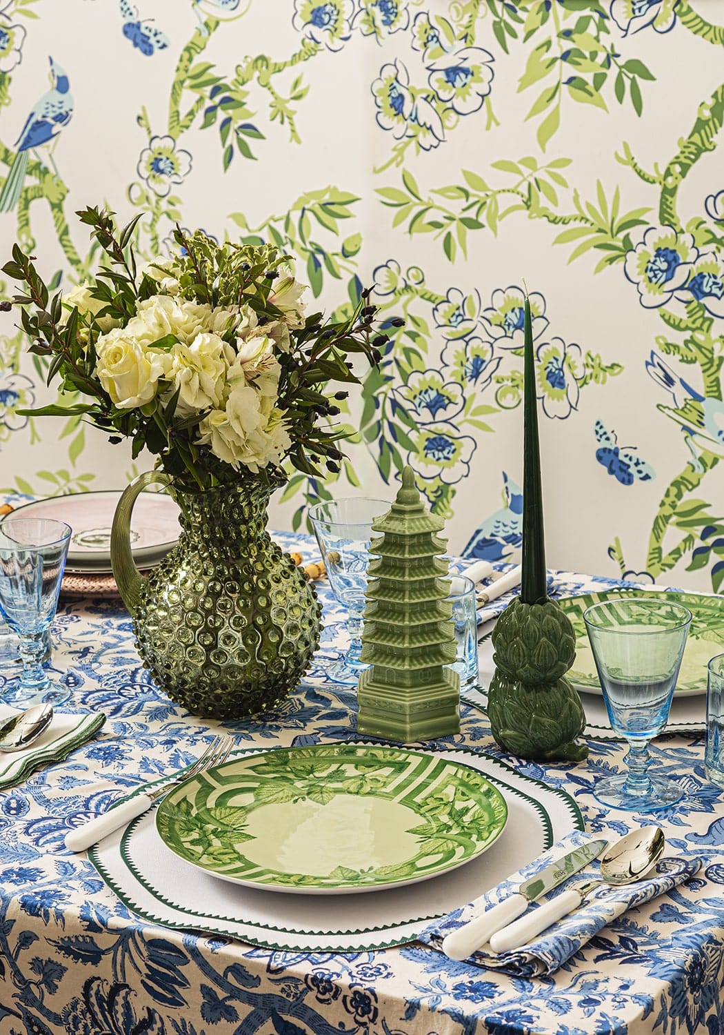 Classic green round placemats set of 4 with a green textured glass pitcher holding white roses and greenery