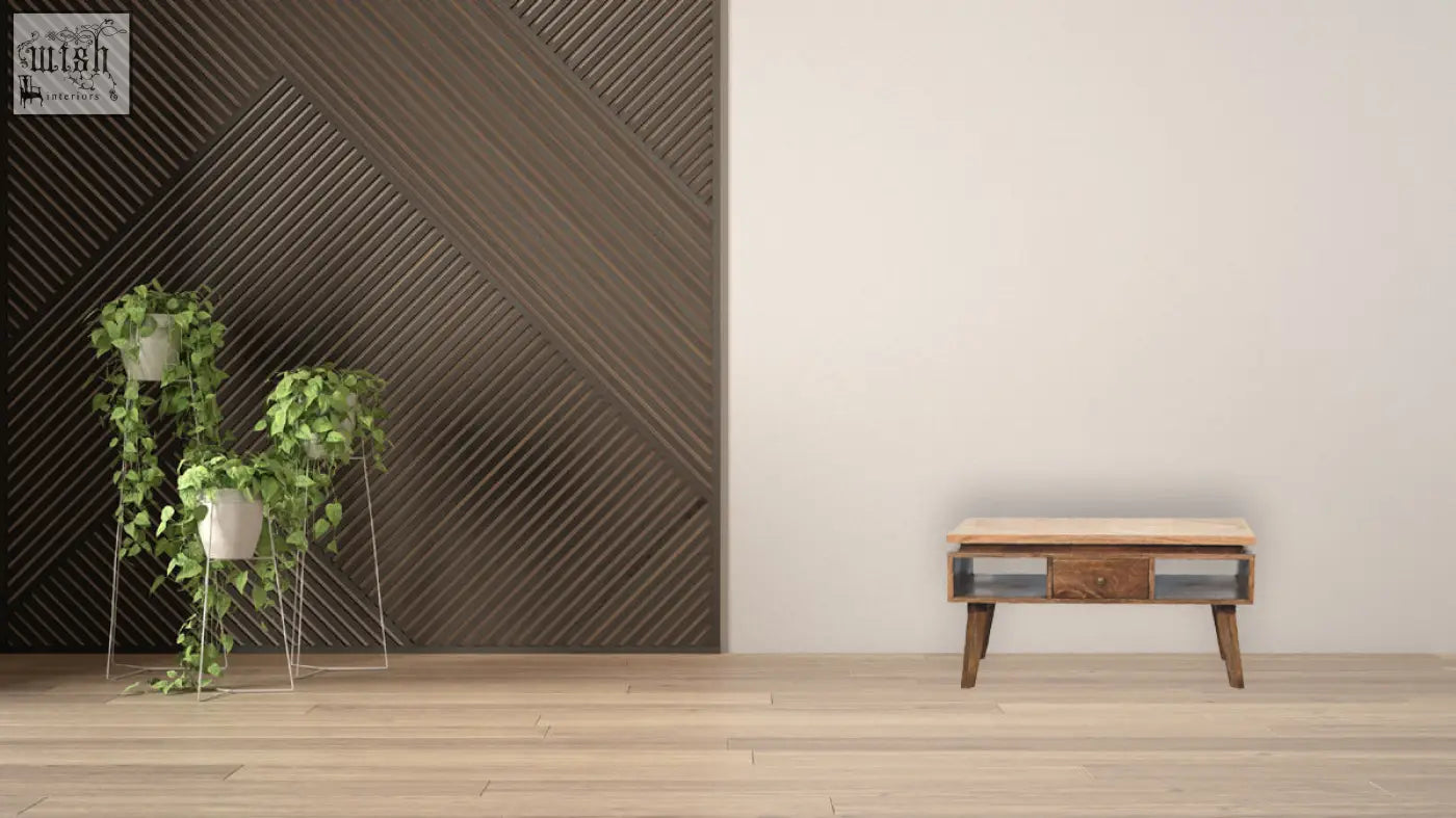 A classic grey granary coffee table with a light wooden top and dark drawer fronts on angled legs
