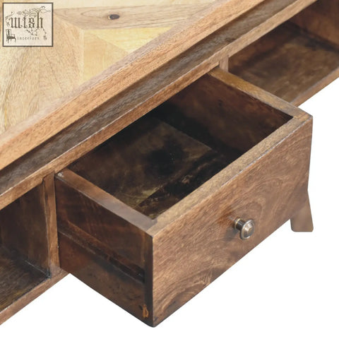 A classic grey granary coffee table with rustic wood, geometric inlay top, and drawers with metallic knobs