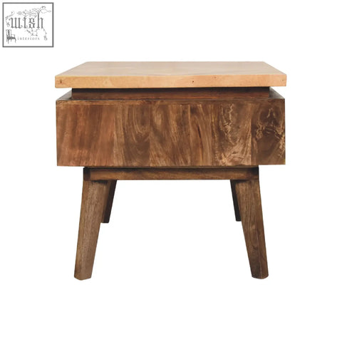 A rustic classic grey granary coffee table with a light wooden top and dark textured sides on angled legs