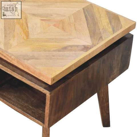 Classic grey granary coffee table with geometric wood inlay top and dark brown legs with lower shelf for storage
