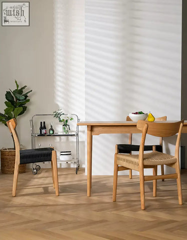 Light wood dining table with smooth natural finish paired with classic hans w ch01 rattan dining chair in light oak