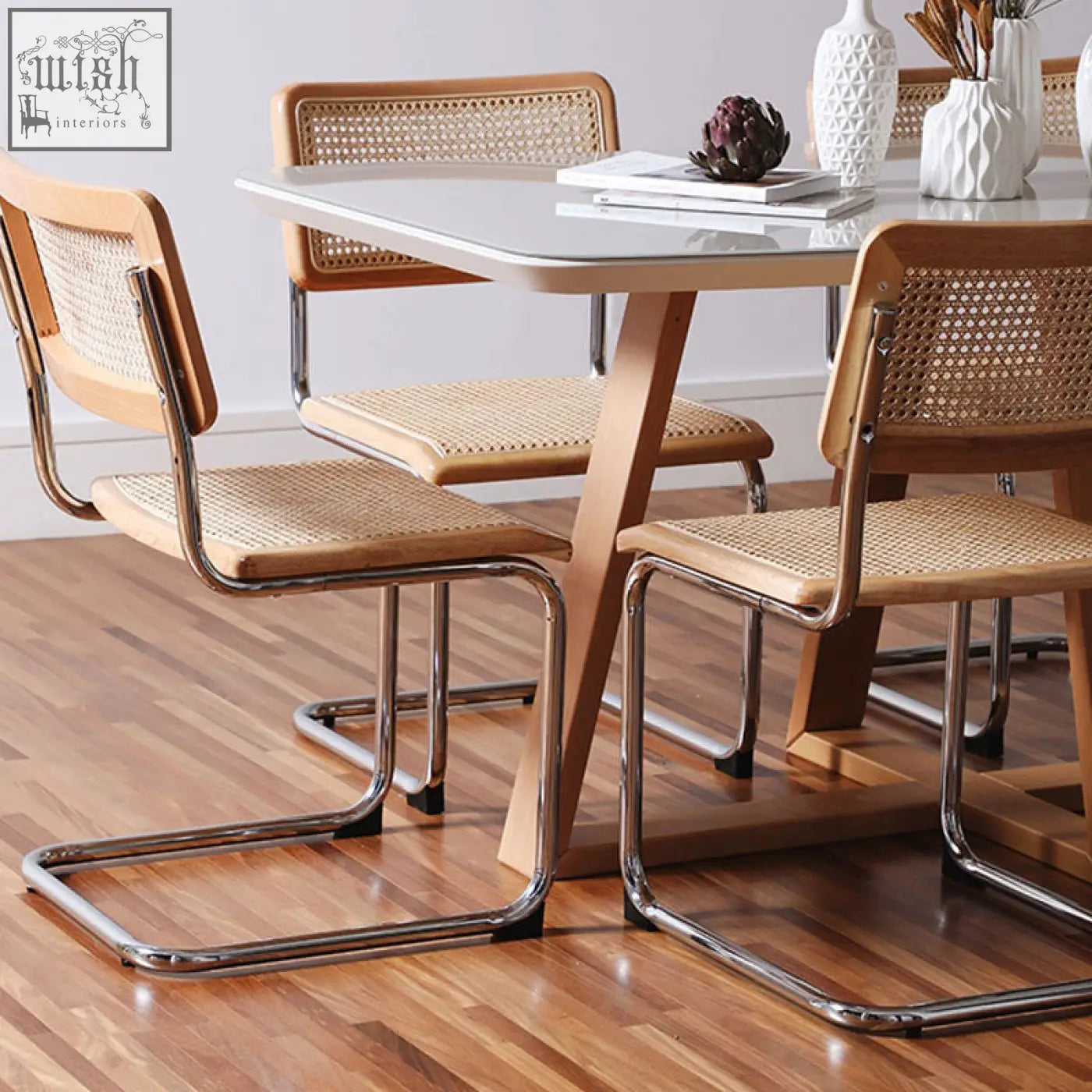 Classic keaton rattan dining chair with light wood frame, woven cane seats and backs, and chrome cantilever legs with armrests