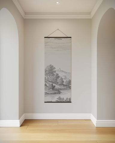 A classic toile black and white jouy tapestry with minimalist tree silhouettes and flowing water on a neutral wall
