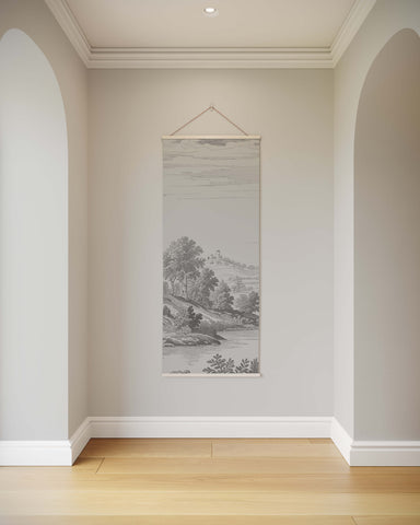A delicate gray classic toile de jouy tapestry with a subtle hand-drawn pastoral scene hanging from a white string