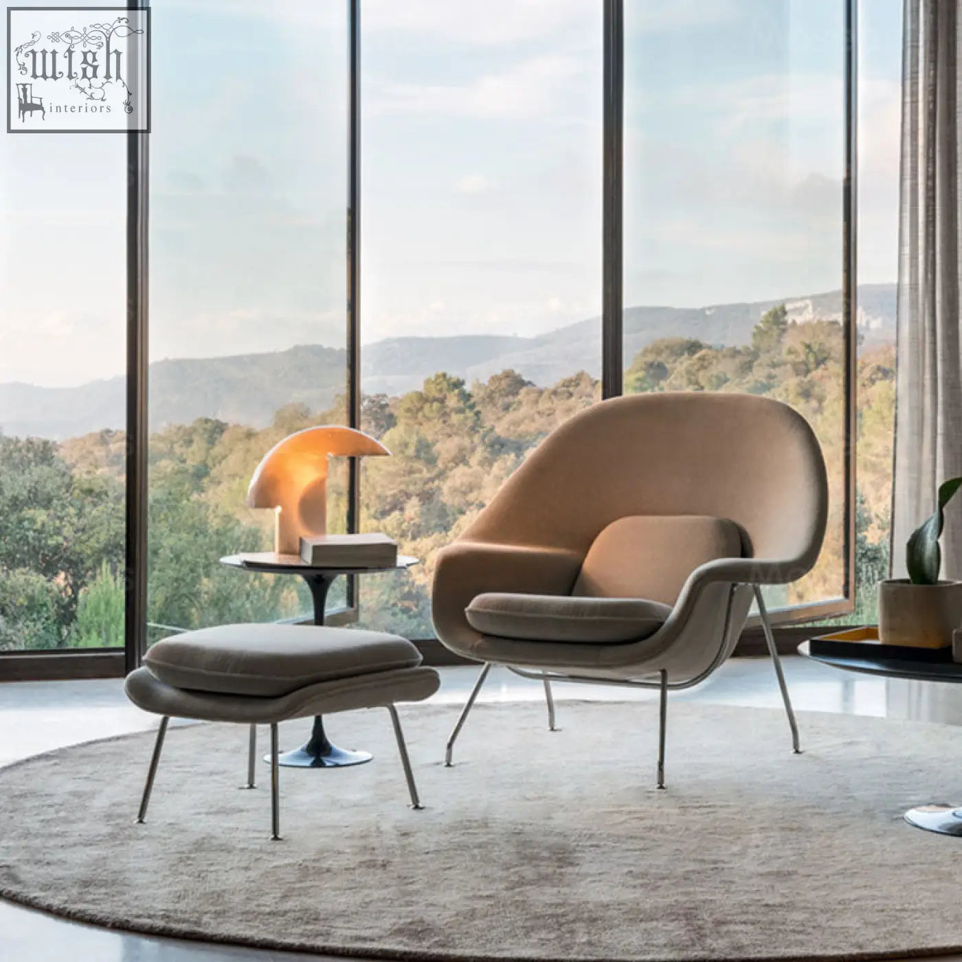Beige classic womb chair with sleek metal legs and matching ottoman in premium velvet or linen upholstery