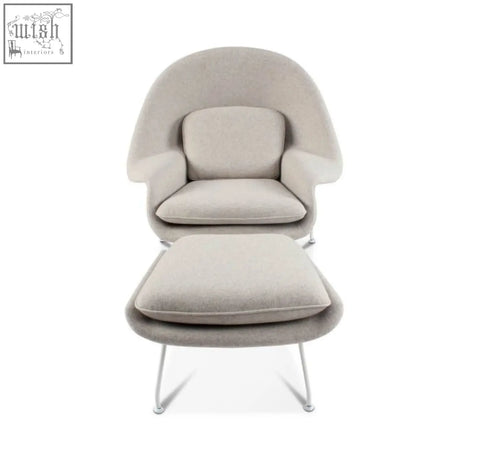 Beige classic womb chair and ottoman with sleek curved design and slender metal legs in premium velvet or linen