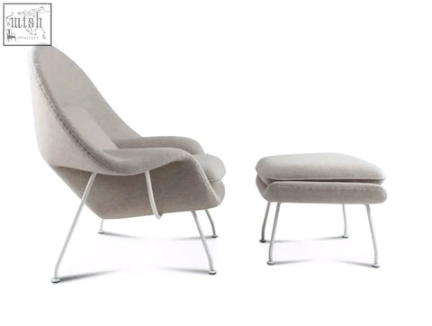 Beige classic womb chair and ottoman with slender white metal legs upholstered in premium velvet or linen