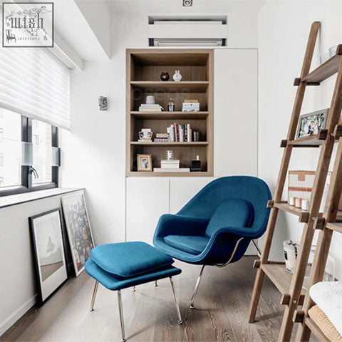 Deep blue velvet classic womb chair with matching ottoman and chrome legs for stylish comfort