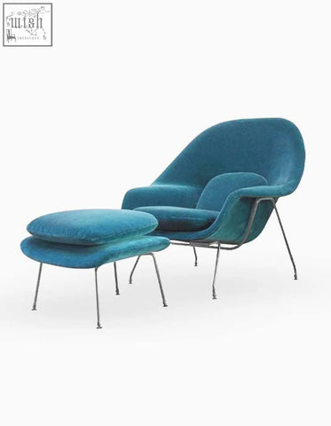 Teal velvet classic womb chair and ottoman with sleek metal legs in modern mid-century design perfect for lounging