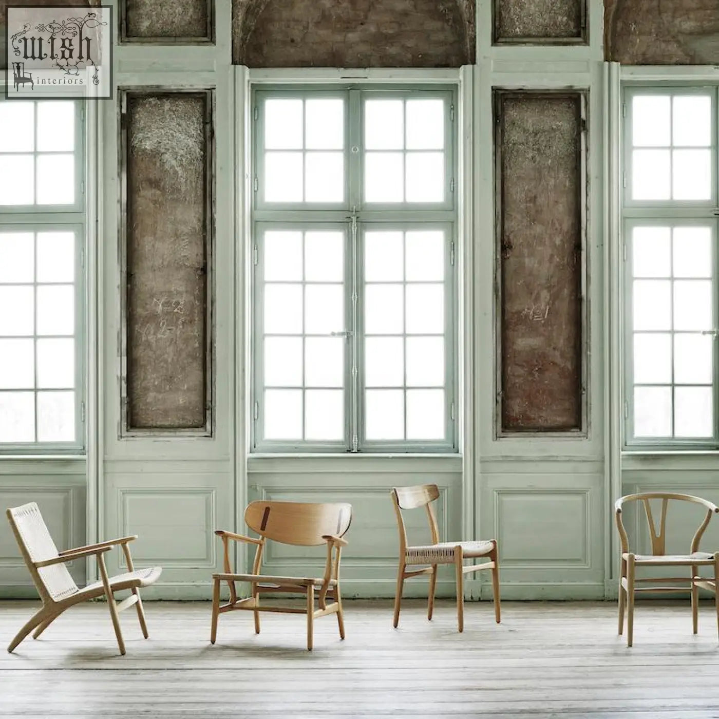 Four minimalist ch01 rattan dining chairs in dark oak with woven seats in a bright spacious room