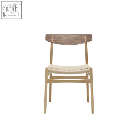 Classical hans.w ch01 rattan dining chair with a light woven seat and dark oak backrest in minimalist style