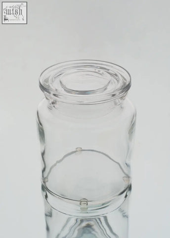 Clear storage jar set featuring a large clear glass jar with matching lid and subtle embossed design near the base